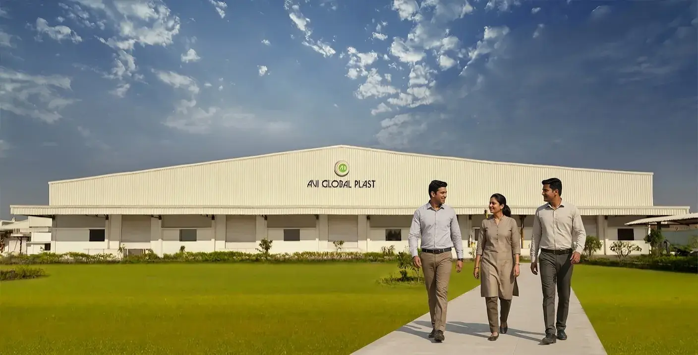 AVI Global Plast team walking outside the Daman manufacturing facility