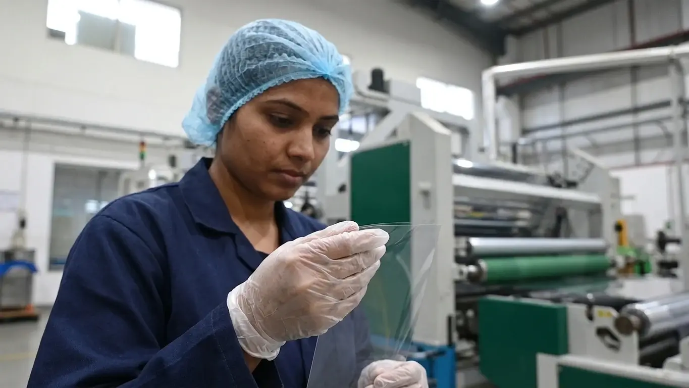 Sheet, machinery and an AVI operator on the production line.